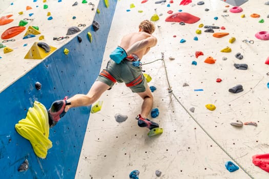 applying magnesium to the hands from the bag before climbing the climbing wall. High quality photo