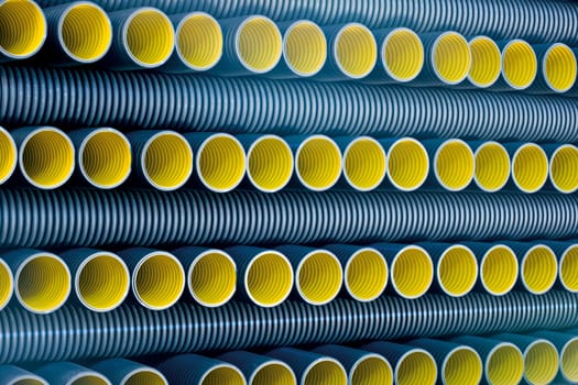 Bunches of PVC pipe sitting on palets at a wholesale pipe store.