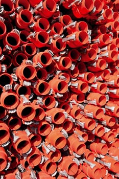 Bunches of PVC pipe sitting on palets at a wholesale pipe store.
