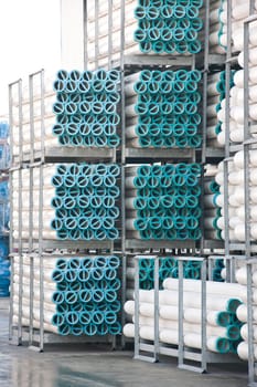 Bunches of PVC pipe sitting on palets at a wholesale pipe store.