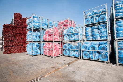 Bunches of PVC pipe sitting on palets at a wholesale pipe store.