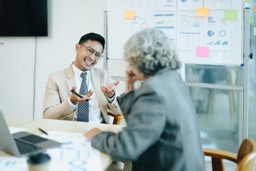 Asian entrepreneurs and business people meeting in a conference room in business planning, financial budget and investment risk assessment to analyze customer groups to increase company growth.