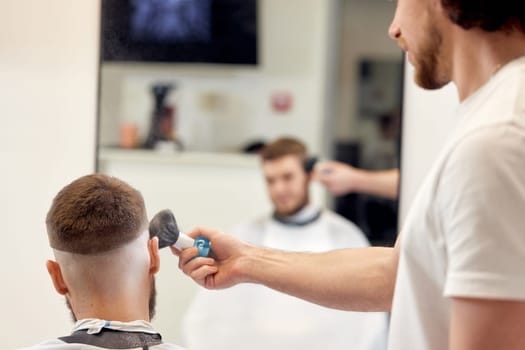 barber holding brush for talco in barber shop. close-up