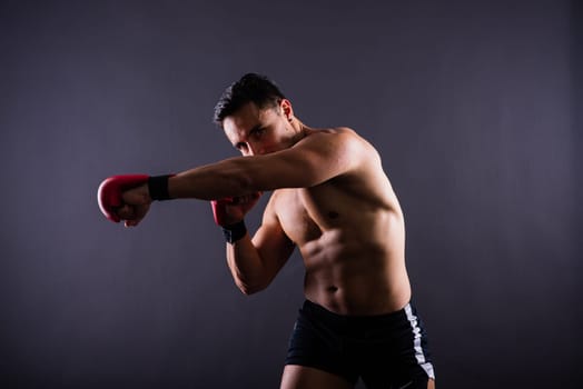 Boxing gloves, man training in a sports fight, challenge or mma competition on studio background.