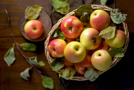 Top view on a ripe apples on a wooden table in basket