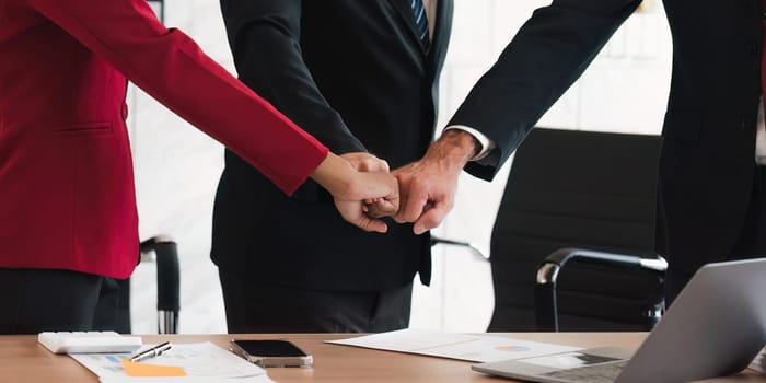 Business team Teamwork , Power, Unity And Partnership Concept. Closeup sropped view of multucultural group of people making fist bump .business team doing fist pump together celebrating good deal.