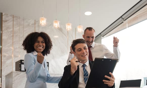 portrait of businesspeople team sitting in conference together in an office with intimate and excited the success on paperwork. Idea for a good relationship of teamwork in business.