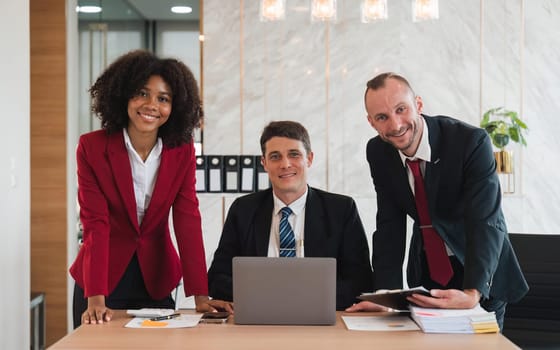 Portrait of successful business team looking at camera and smiling.