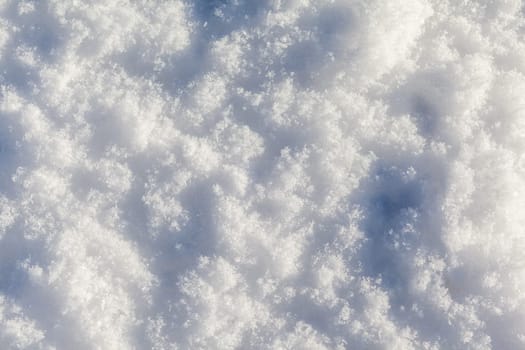 Clean, white snow close-up. Winter background. Snow surface. Fresh fluffy white snow texture.White snowflakes. High quality photo