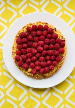 bright crimson-sand cake on yellow napkin, top view.