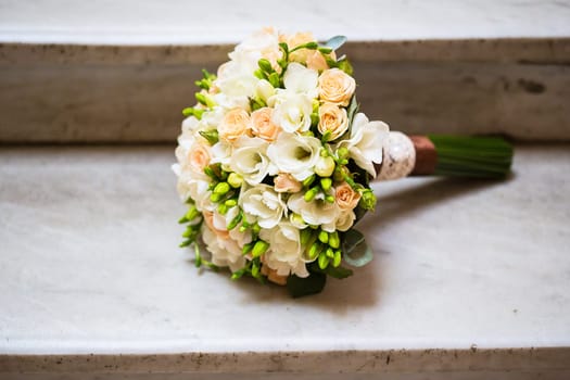 beautiful wedding bouquet on the marble staircase