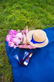 Beautiful flowers in a basket stand on the grass-picnic