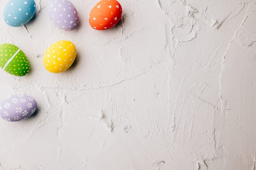 Easter Day Concept. Top view holiday banner background web design white colorful easter eggs painted on white cement background with empty copy space, celebration greeting card, overhead, template