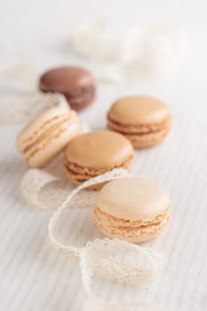 Colorful pastel eco handmade natural macaroons on white background. Gift for 8 March, International Women's Day, Valentine Day. Vertical photo