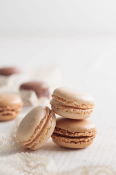 Colorful pastel eco handmade natural macaroons on white table. Gift for 8 March, International Women's Day, Valentine Day. Vertical stack