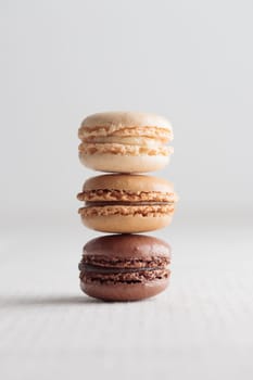 Colorful pastel eco handmade natural macaroons on white background. Gift for 8 March, International Women's Day, Valentine Day. Vertical stack