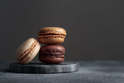 Chocolate eco handmade natural macaroons on dark background in the darkmood style. Horizontal banner top view with a copyspace