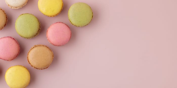 Macaroons on pink background, colorful french cookies pattern. Gift for 8 March, International Women's Day, Valentine Day. Horizontal banner with copyspace