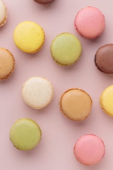 Macaroons on pink background, colorful french cookies pattern. Gift for 8 March, International Women's Day, Valentine Day. Vertical