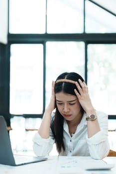 Portrait of sme business owner, woman using computer and financial statements Anxious expression on expanding the market to increase the ability to invest in business.