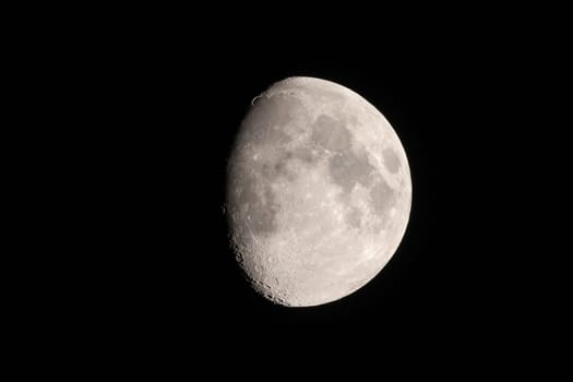 Telephoto image of waxing three-quarter moon end of February 2023 with mountains and mare against black sky