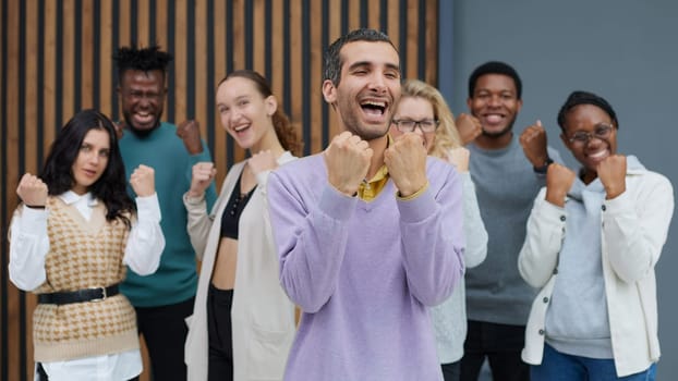 Happy people raise their hands up clenching their fists. Success concept