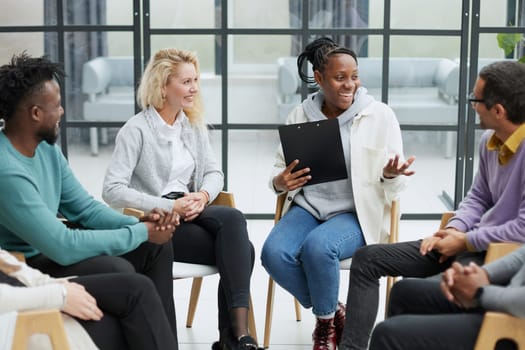 conducts business training with a group of young people.