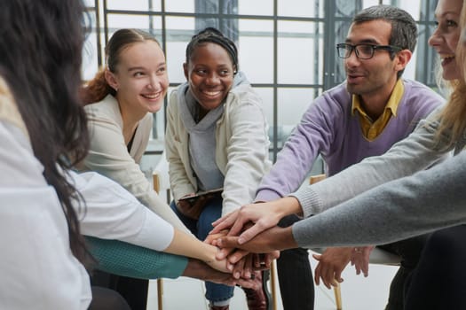 close-up of a business team sitting holding hands