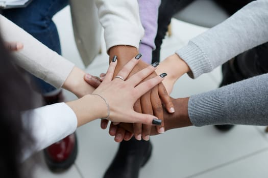 close-up of a business team sitting holding hands
