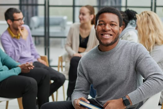Gathered happy young businessmen holding negotiations, meeting with friendly diverse colleagues