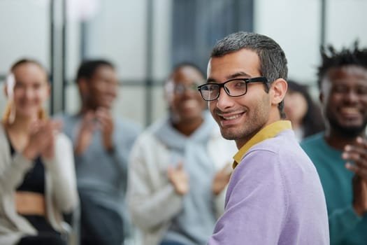 Positive people sitting on a chair, taking part in a team building or therapy session