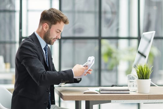 Businessman Taking Papers From Secretary In Office