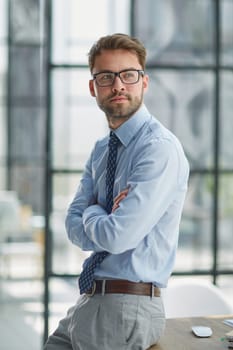 Young cheerful businessman working at office