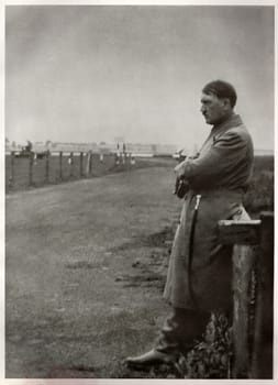 GERMANY - 1932: Photo of Adolf Hitler, leader of nazi Germany. Lonesome Hitler on the road. Reproduction of antique photo