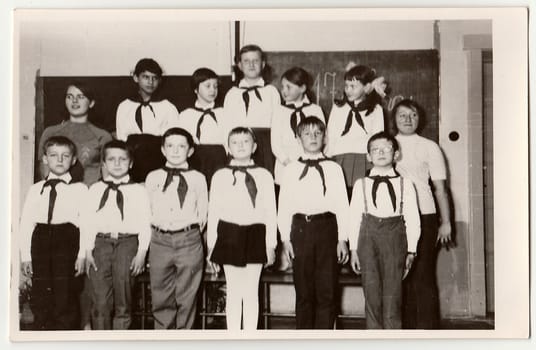THE CZECHOSLOVAK SOCIALIST REPUBLIC - CIRCA 1980s: Vintage photo shows pupils with a pioneer red ties in the classroom.