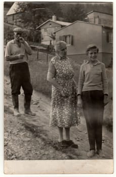 THE CZECHOSLOVAK SOCIALIST REPUBLIC - JULY 1964: Vintage photo shows grandparents and their grandson in the village.
