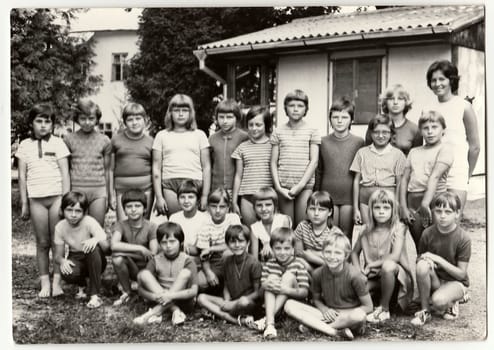 THE CZECHOSLOVAK SOCIALIST REPUBLIC - CIRCA 1980s: Vintage photo shows teenagers and female chiefs at summer camp.
