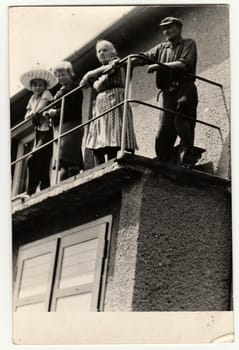 THE CZECHOSLOVAK SOCIALIST REPUBLIC - JULY 1965: Vintage photo shows people on the balcony.