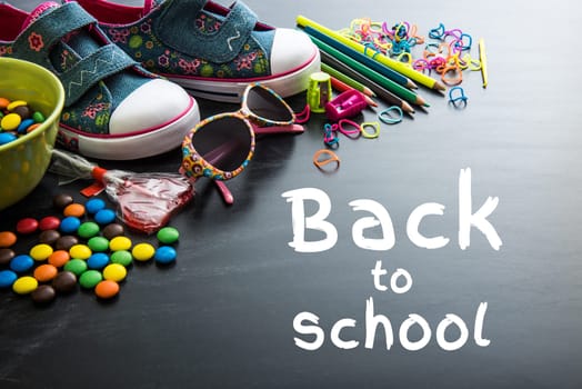 Back to school concept. Kids stuff and sweets on a white background