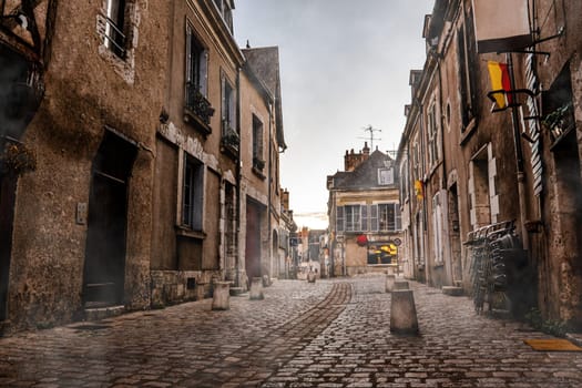 Central street in Blois, France. Beautiful morning city with mist,