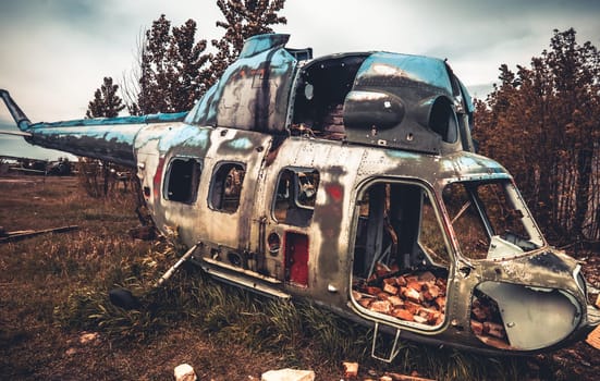 Abandoned destroyed old helicopter at the airfield. Soviet Union army technique