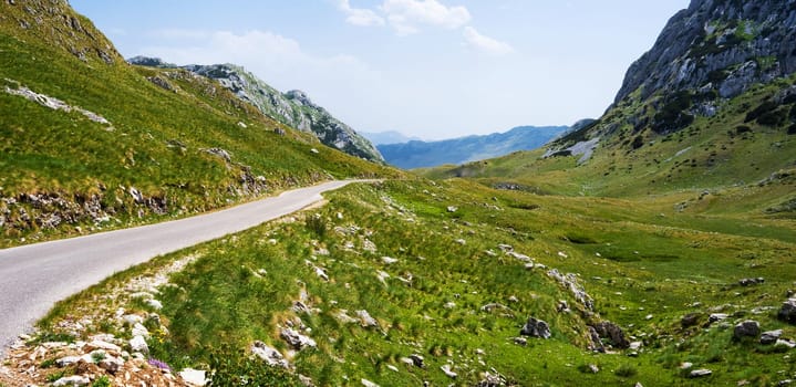 Scenic road way with mountains view in National park Durmitor in Montenegro. Amazing balkan nature in summertime