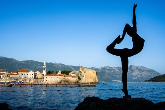 Budva, Montenegro - 27 July 2021: Ballerine sculpture in Budva, Montenegro. Adriatic sea view on ancient old city and mountains