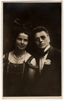 THE CZECHOSLOVAK REPUBLIC - CIRCA 1920s: Vintage photo shows a young couple. Antique black & white photo with dark tint.