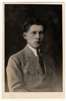 THE CZECHOSLOVAK REPUBLIC - CIRCA 1920s: Vintage photo shows young man wears posh light jacket. Antique black white studio portrait.