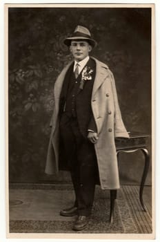 THE CZECHOSLOVAK REPUBLIC - CIRCA 1920s: Vintage photo shows young groom wears his posh (Sunday best) clothes. Antique black white studio portrait.