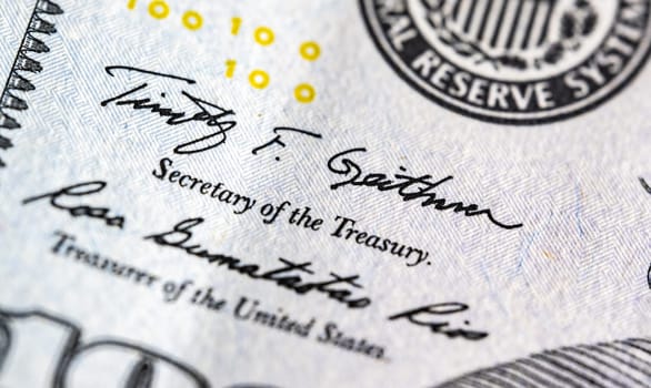 Close up macro view of one hundred American dollars bill fragment with treasuruty sign. United States currency.