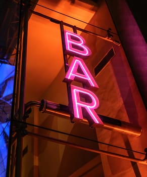 Colourful neon signboard bar lightning and flashing at night city