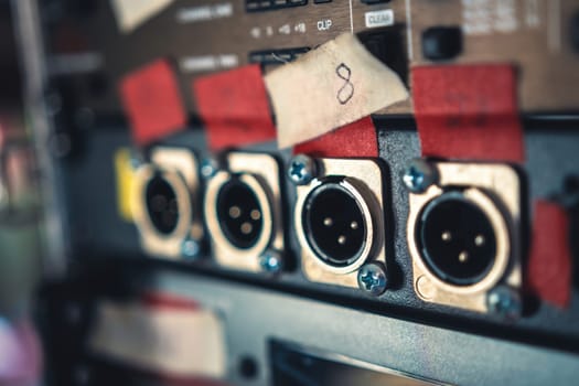 Music mixer panel with microphone connector ports in recording studio closeup. Professional musical equipment console for song production