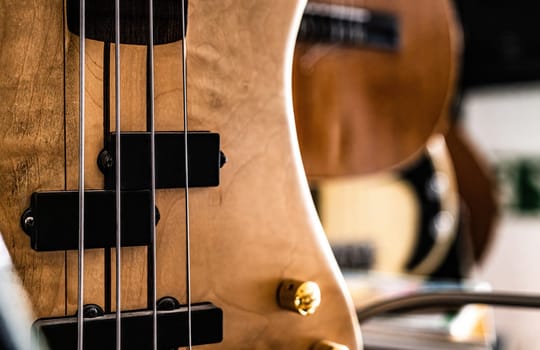 Bass guitar fretboardsand strings in music recording studio closeup. Musical instrument for live acoustic pop and rock perfomance